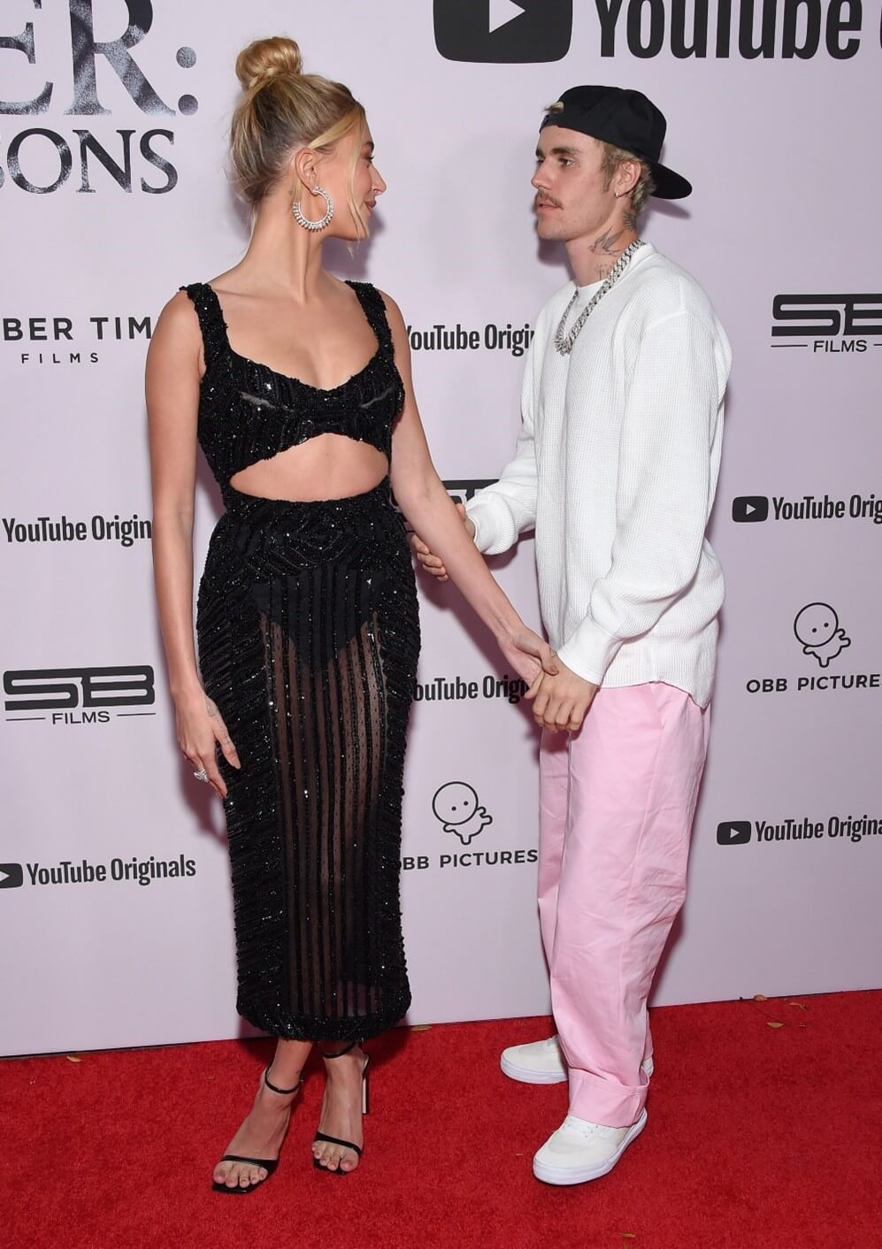 justin bieber and hailey bieber posing for camera, red carpet look
